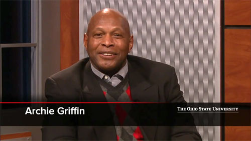 Photo shows Archie Griffin speaking in a Feb 2014 interview with Ohio state president designate Michael Drake. 